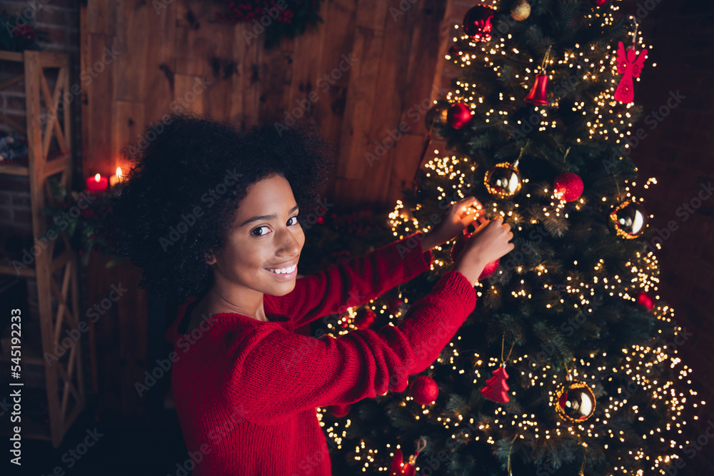 Photo of adorable positive child teenager curly hair red pullover decorate evergreen dream magic moment cozy season time evening indoors Photo of adorable positive child teenager curly hair red pullover decorate evergreen dream magic moment cozy season time evening indoors