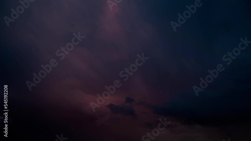 Beautiful time lapse of darkening sky with purple clouds photo