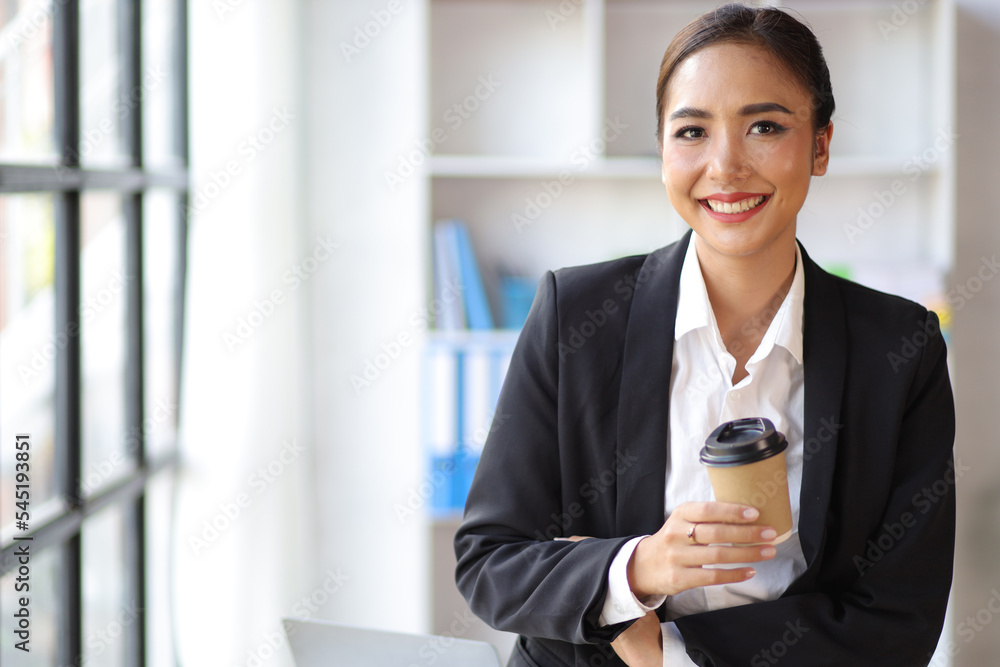 Portrait of charming businesswoman in office happy and drinking hot coffee. Portrait of charming businesswoman in office happy and drinking hot coffee.