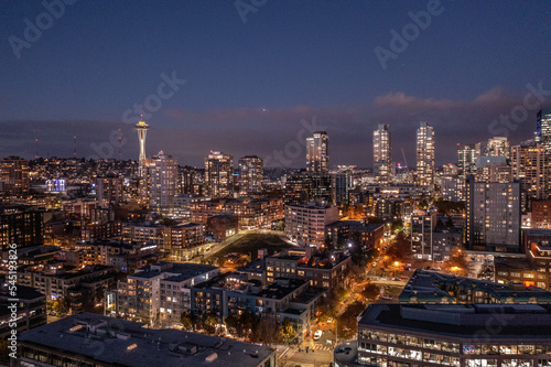 Seattle, Washington, USA - November 2022, night aerial view of illuminated Seattle Downtown and the Waterfront pier area with famous Space Needle Tower - aerial night view 