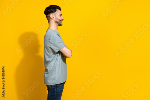 Profile side photo of cheerful man wear trendy clothes look empty space satisfied own appearance isolated on yellow color background
