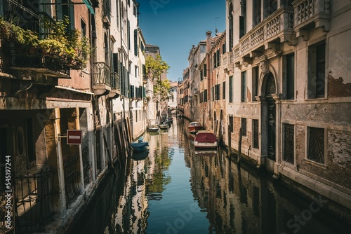 Narrow canal between ancient buildings in Venice, Italy Fototapeta
