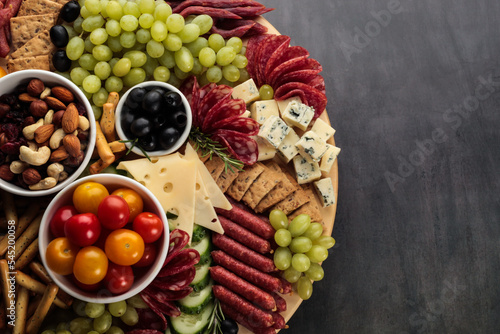 Картината върху платно The traditional Spanish choice is Tapas A lavish charcuterie board brimming with an assortment of nuts, fruits, and meats, inviting a communal gastronomic adventure