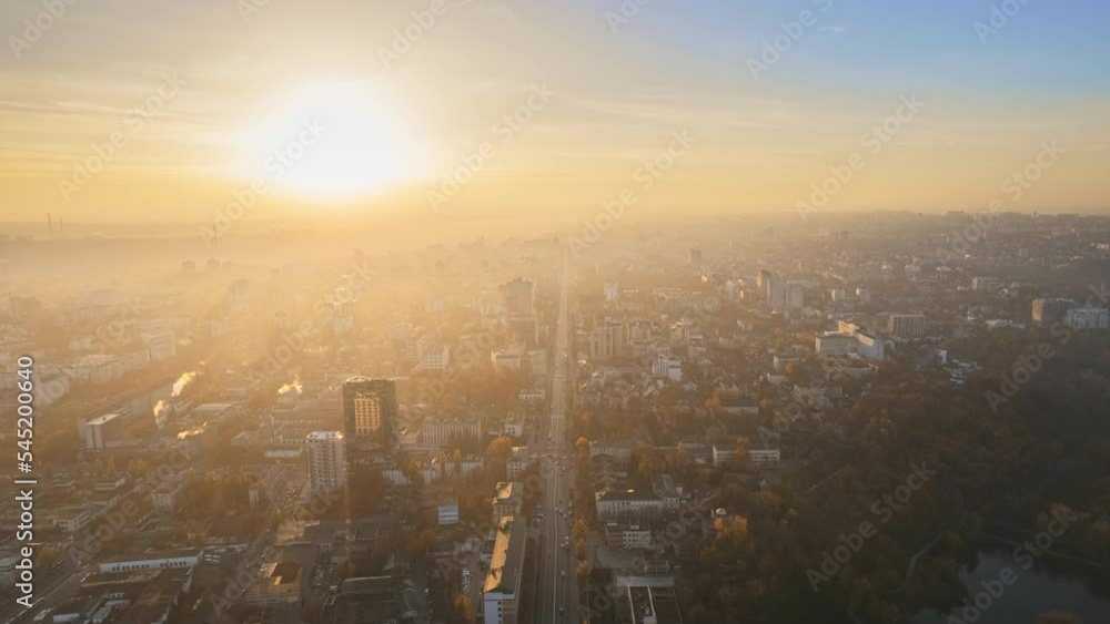 Aerial drone timelapse view of Chisinau at sunrise, Moldova. View of the city with fog in the air, multiple buildings, Dendrarium park and streets with yellowed trees Aerial drone timelapse view of Chisinau at sunrise, Moldova. View of the city with fog in the air, multiple buildings, Dendrarium park and streets with yellowed trees