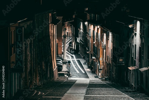 Closed old traitional empty street with closed shops and street lights at night photo