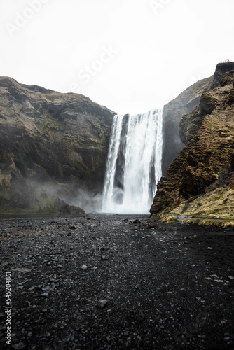 Vertical shot of  the Skogafoss waterfall in Iceland flowing down the cliff