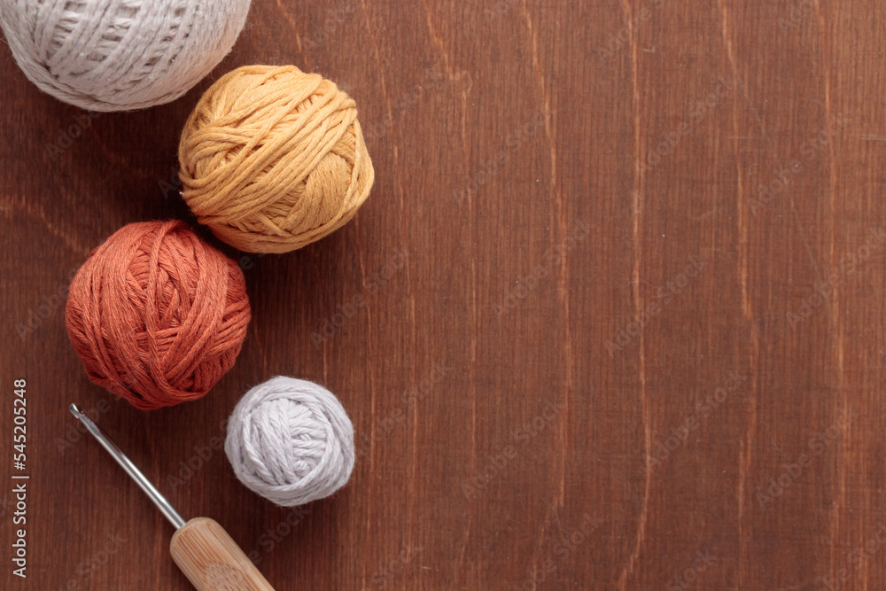 Cotton Yarn Balls for Crocheting Handmade on a Light Colored Wooden background