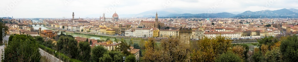 Panoramic urban scenery of Florence with a cloudy sky and foggy mountains background, Italy