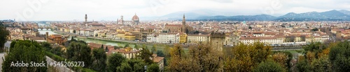 Panoramic urban scenery of Florence with a cloudy sky and foggy mountains background, Italy