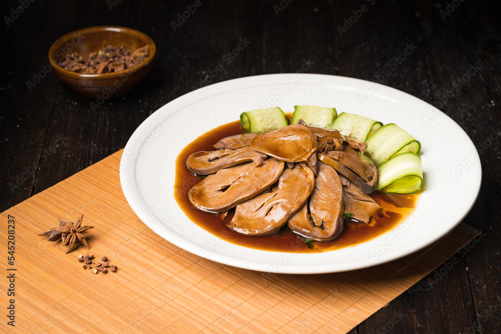 Special Chinese food braised pork heart on retro background Special Chinese food braised pork heart on retro background