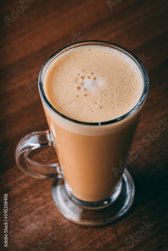 Vertical shot of a glass of latte
