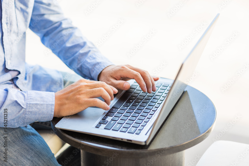 Side view of male businessman hands typing on laptop keyboard. Side view of male businessman hands typing on laptop keyboard.