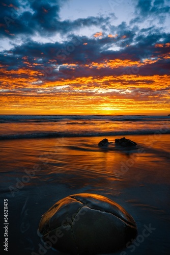 Fototapeta Naklejka Na Ścianę i Meble -  Vertical of Moeraki Boulders Beach in Hampden, New Zealand at sunset