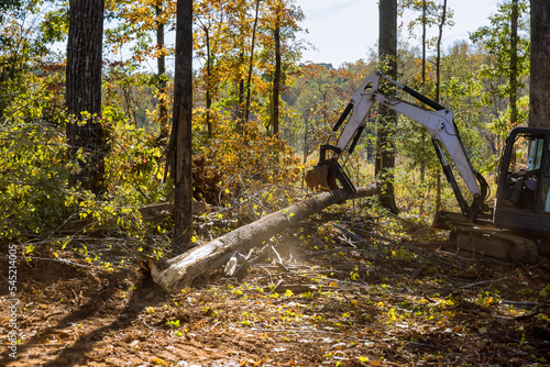 Canvas Print Landscaping work to clear land roots as part of housing development subdivision, using tractors skid steers