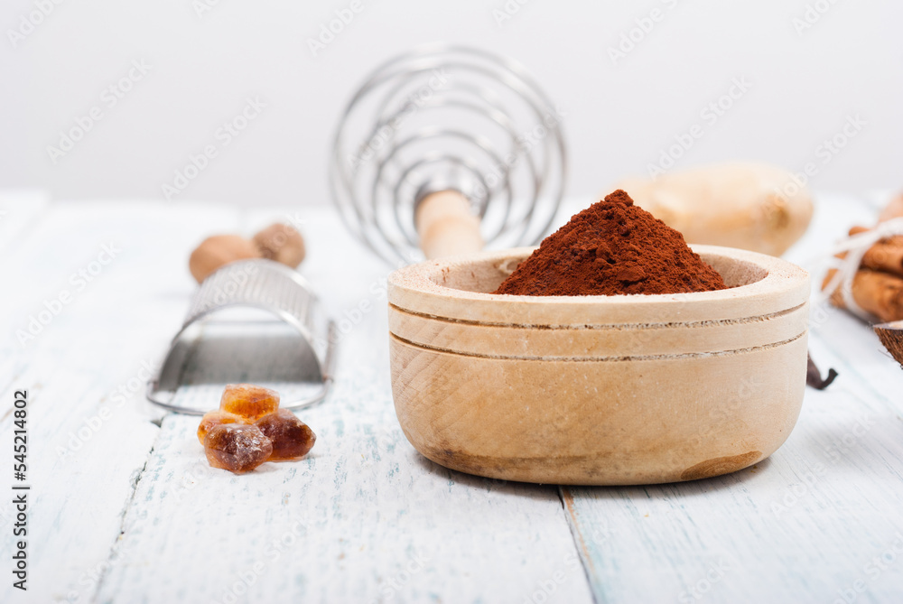 pile of cocoa powder, sugar and dessert ingredients, kitchen utensils on old white wooden pile of cocoa powder, sugar and dessert ingredients, kitchen utensils on old white wooden