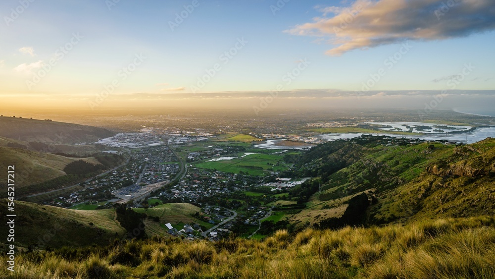 Beautiful view of the town on the green valley at sunset. Christchurch, New Zealand.