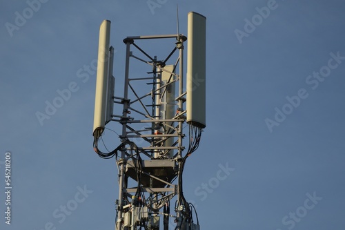 A Telecommunication antenna mast with blue sky background, France