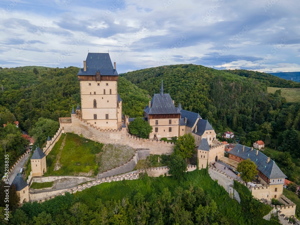 Gothic architecture style Karlstejn Castle on the green hill, Bohemia, Czech Republic, aerial view