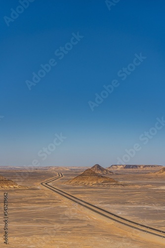 Vertical aerial shot of the road through the Black Desert, Egypt.