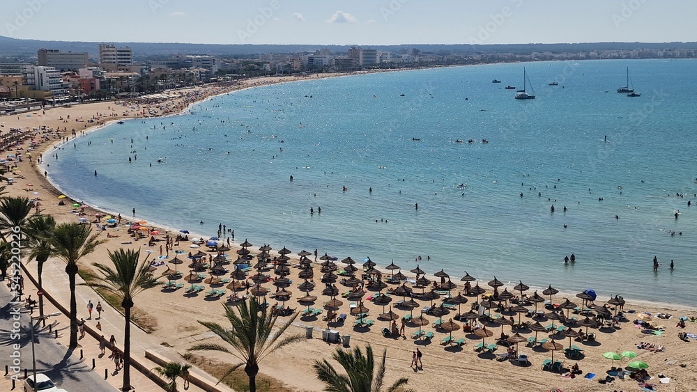 Fototapeta premium Aerial view of people vacationing at Playa de Palma beach resort in Mallorca, Spain