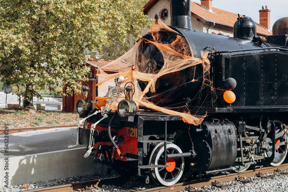 Entrevaux, France - 30.10.2022 :  the 1920s vintage steam train in Provence decorated for Halloween