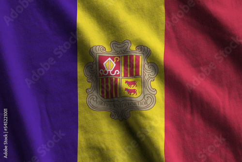 Andorra flag with big folds waving close up under the studio light indoors. The official symbols and colors in banner photo