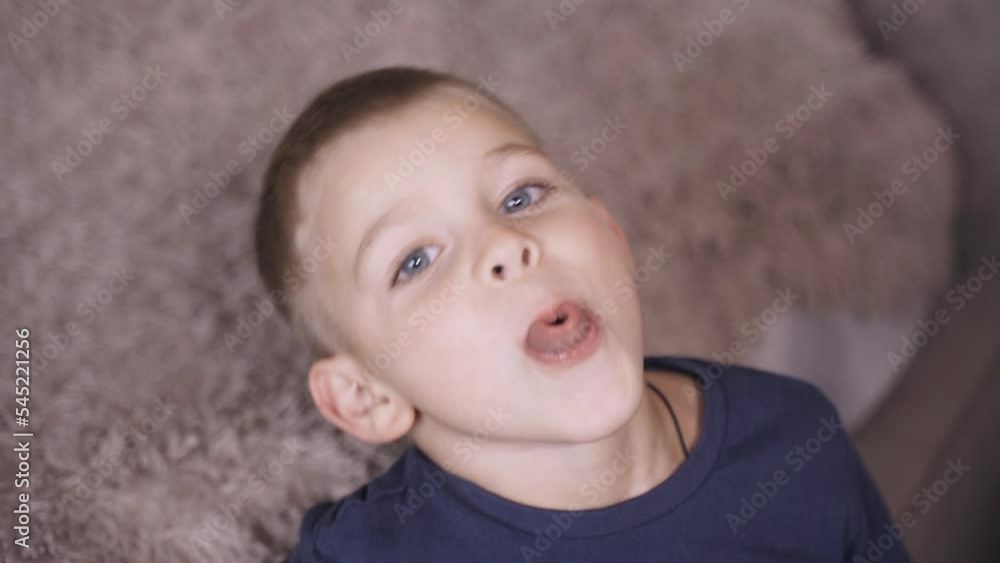 Gymnastics for the development of speech. The boy demonstrates his skills in twisting his tongue into a tube, doing exercises to develop speech. Gymnastics for the development of speech. The boy demonstrates his skills in twisting his tongue into a tube, doing exercises to develop speech.