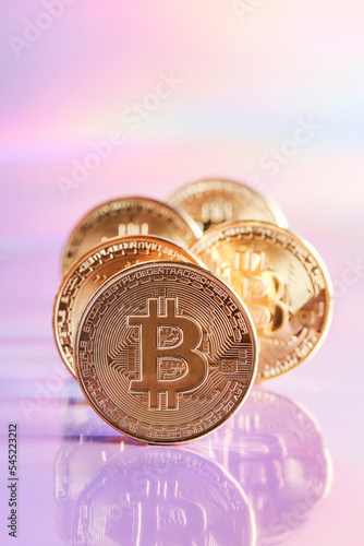 Golden bitcoin coins on holographic, abstract, neon background. digital currency, business style. Mining and trade bitcoin concept. selective focus photo