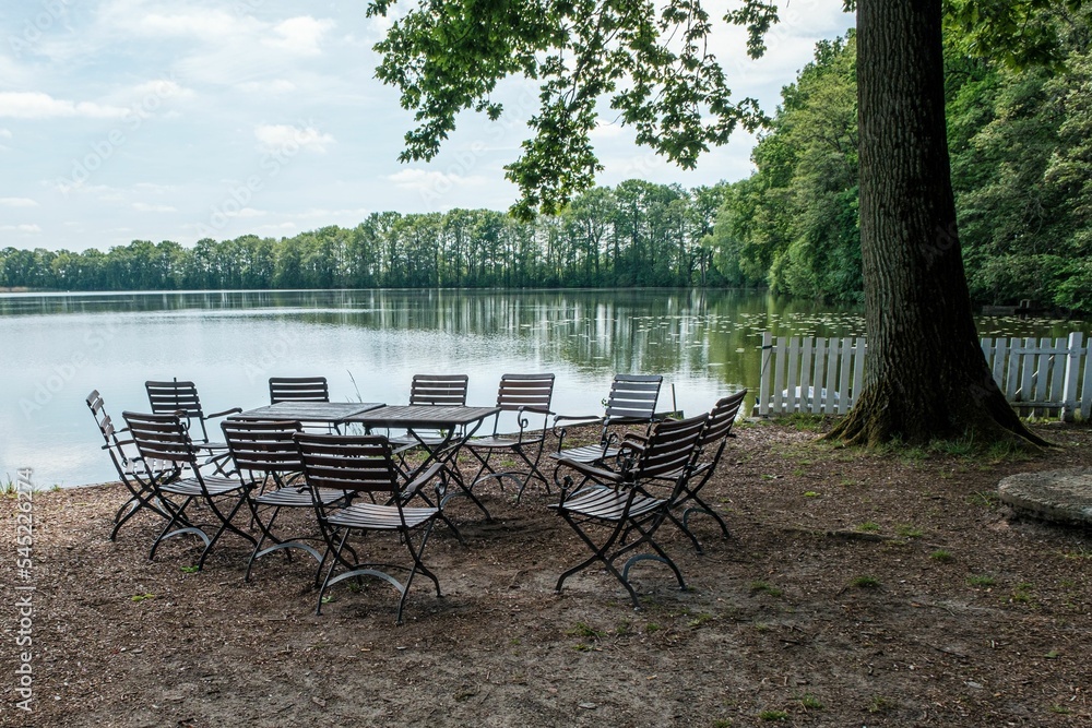 Table with chairs on the lake shore Table with chairs on the lake shore