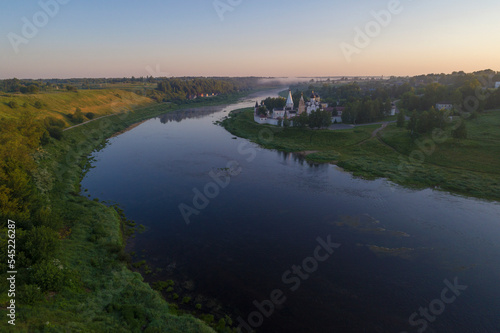 July dawn on the Volga river. View of the Staritstsa Holy Assumption Monastery  aerial photography . Tver region  Russia