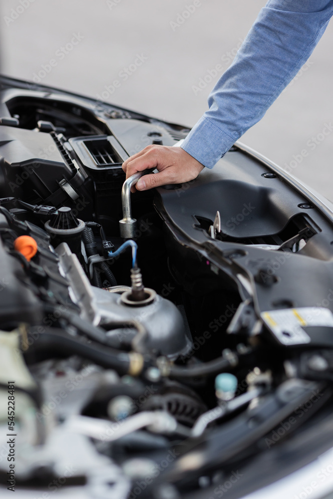 Man with checking car engine. Man with checking car engine.