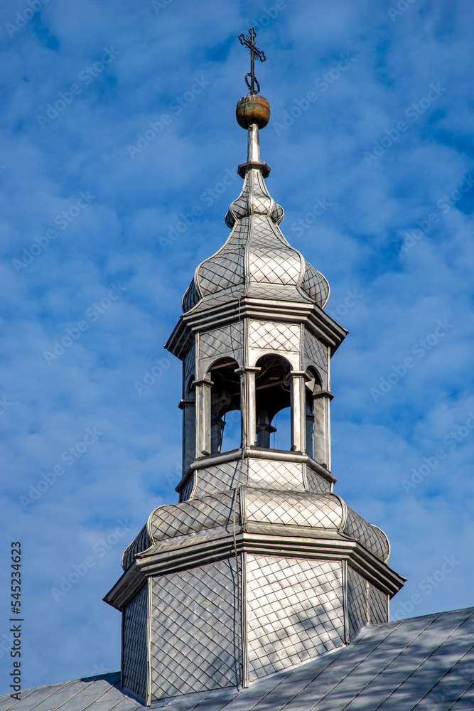 General view and architectural details of the wooden belfry and the neo-Gothic Catholic church of Saint John the Baptist built in 1874 in the village of Żmijewo Kościelne in Masovia, Poland.