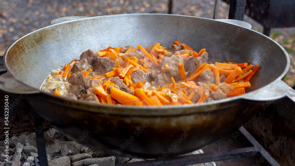 Meat with carrots fried in a pan Meat with carrots fried in a pan