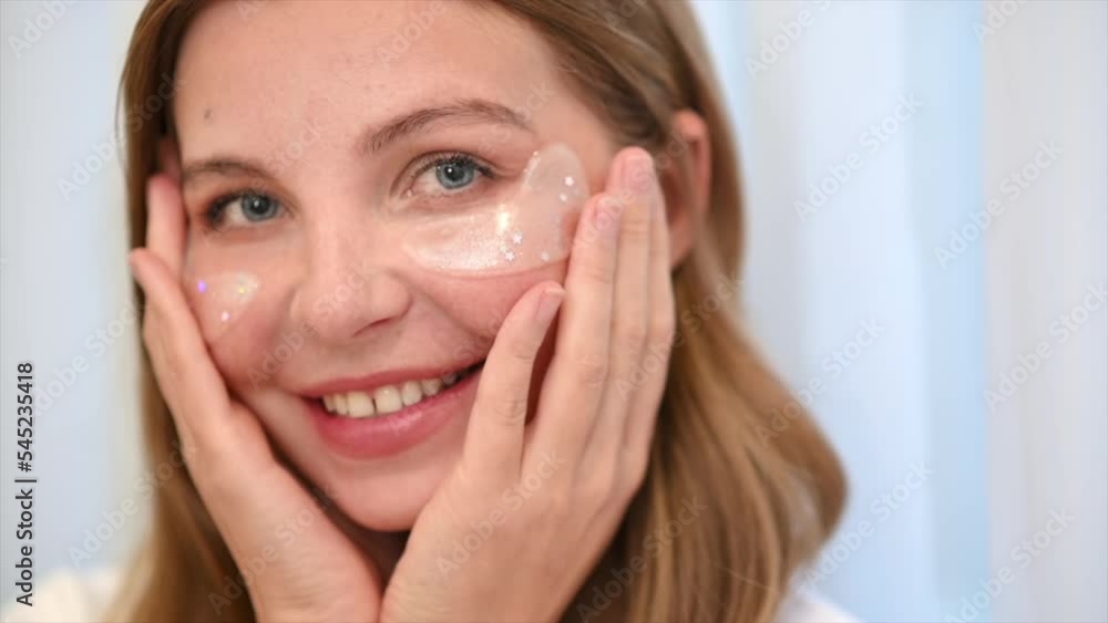 A young caucasian smiling woman is making a face mask A young caucasian smiling woman is making a face mask