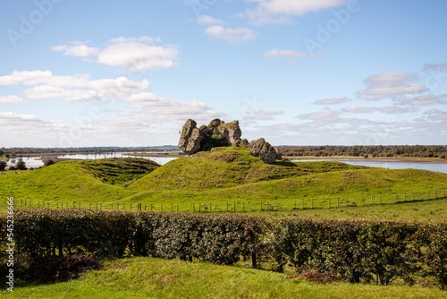 Beautiful shot of the ruins of Clonmacnoise on a green hill in County Offaly, Ireland photo
