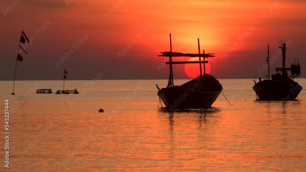 Sunset seascape with small wooden boats and the sun in 4K footage. Sunset seascape with small wooden boats and the sun in 4K footage.