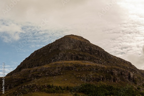 Big rocky cliff against the blue sky during the daytime