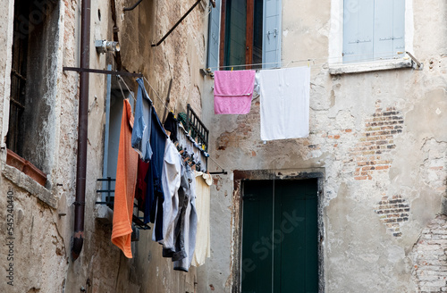 Home laundry hanging on a rope and drying outdoor in the clean air saving the environment. © Michalis Palis