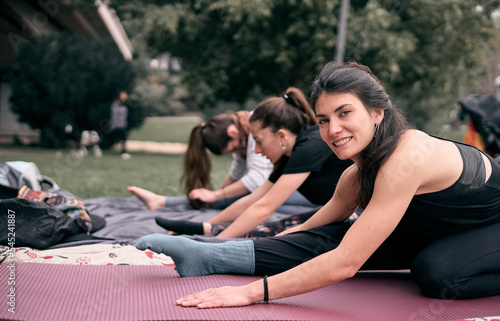 Young caucasian women stretching before their workout in a city park.