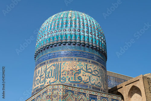The dome of the medieval Bibi-khanum mosque (1404) close-up against a cloudless sky. Samarkand, Uzbekistan