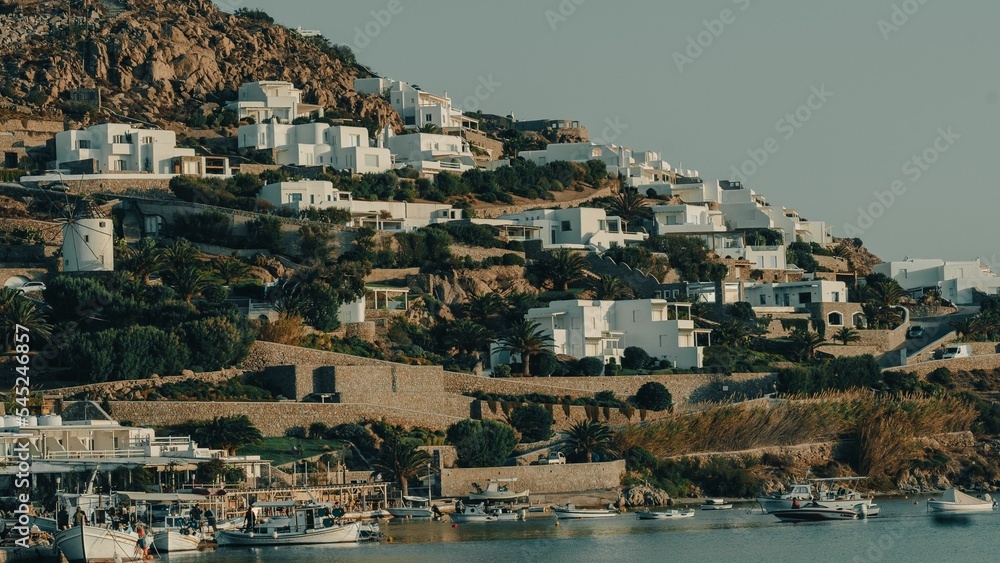 Distant shot of Mykonos Island with white buildings near the harbor, Greece