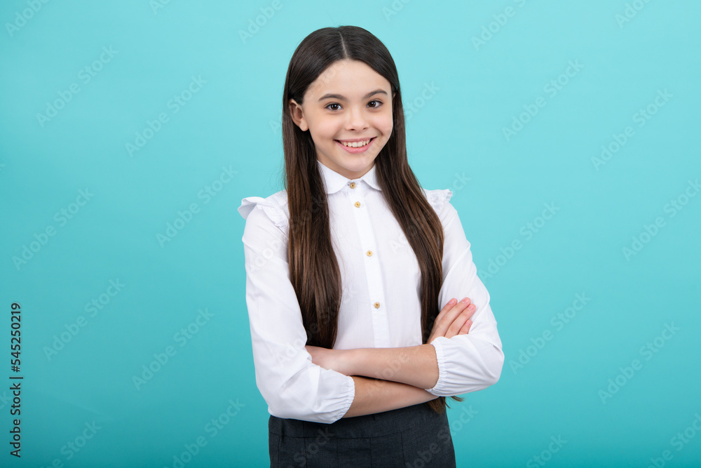 Portrait of teenager girl crossed arms isolated on blue background. Children lifestyle childhood concept. Portrait of teenager girl crossed arms isolated on blue background. Children lifestyle childhood concept.