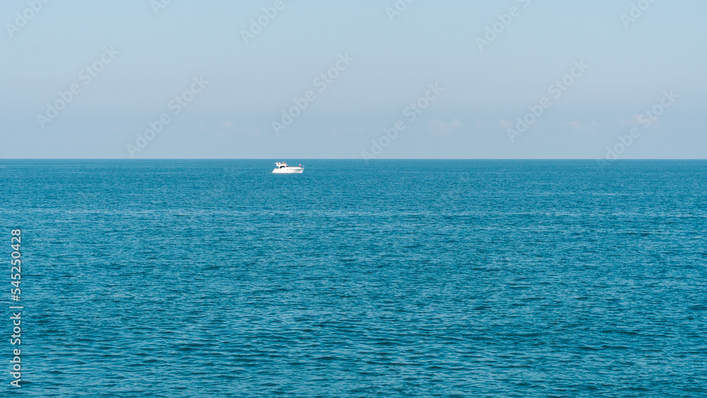 White boat on the horizon of the sea, Batumi