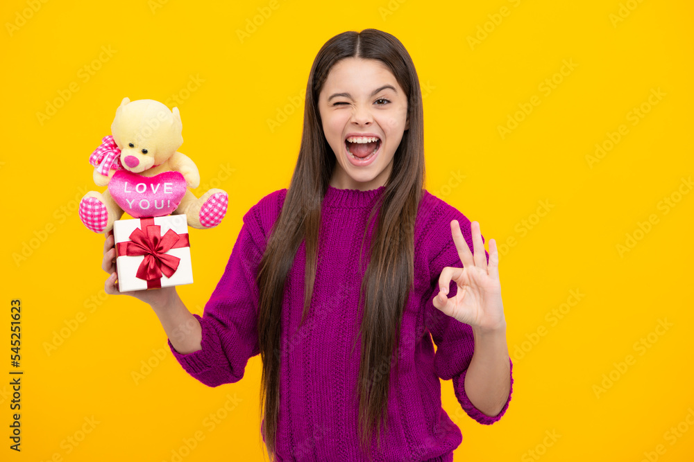 Excited kids face. Child with gift present box on isolated background. Presents for birthday, Valentines day, New Year or Christmas. Amazed expression, cheerful and glad. Excited kids face. Child with gift present box on isolated background. Presents for birthday, Valentines day, New Year or Christmas. Amazed expression, cheerful and glad.