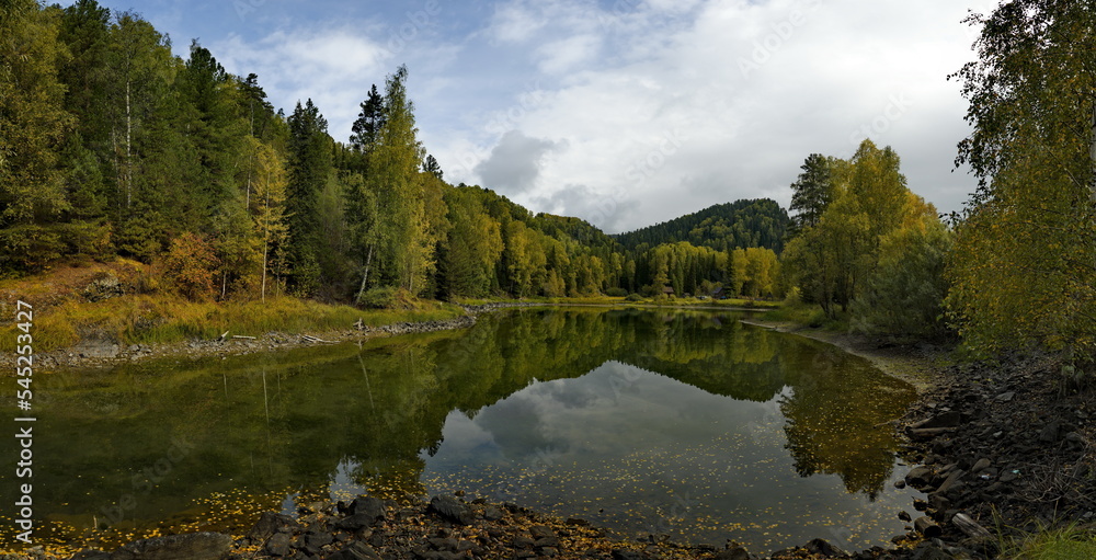 Russia. The South of Western Siberia, the Altai Mountains. The reflection of the mountain on the surface of an inconspicuous lake near the village of Kebezen on the coast of the Biya River. Russia. The South of Western Siberia, the Altai Mountains. The reflection of the mountain on the surface of an inconspicuous lake near the village of Kebezen on the coast of the Biya River.