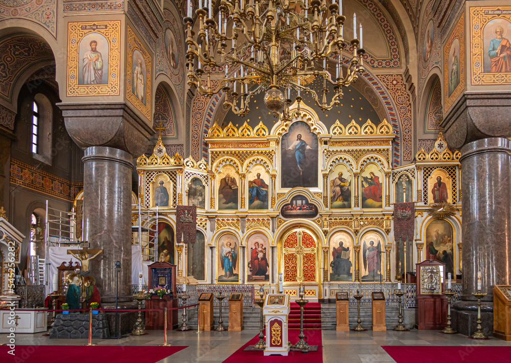 Helsinki, Finland - July 20, 2022: Uspenski Cathedral. Highly decorated with paintings set in golden backdrop of reredos is main entry into sanctuary. Chandeliers, pillars, Jesus on the cross and more