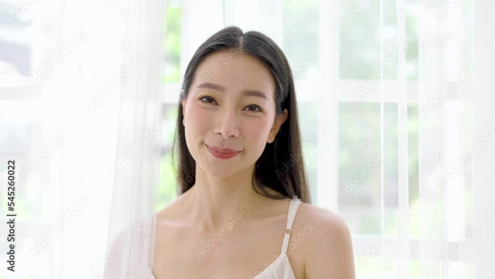 Portrait of young beautiful sexy asian woman relax in bedroom. Smile happy face asian girl look up on white certain. Beauty treatment perfect clear skin makeup spa asia lifestyle. Portrait of young beautiful sexy asian woman relax in bedroom. Smile happy face asian girl look up on white certain. Beauty treatment perfect clear skin makeup spa asia lifestyle.