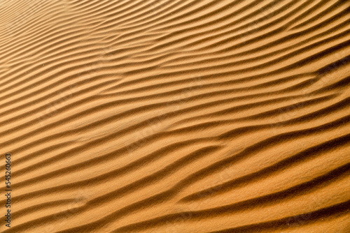 Natural pattern closeup of the sand dune in the desert in Abu Dhabi. Diagonal abstract texture.