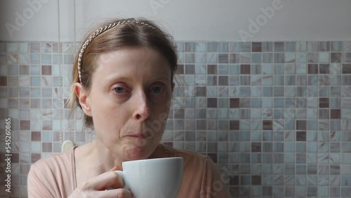 Woman drinking a sip of espresso coffee from a cup