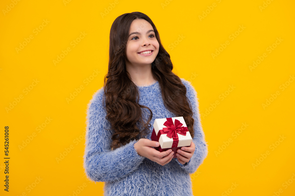 Emotional teenager child hold gift on birthday. Funny kid girl holding gift boxes celebrating happy New Year or Christmas. Happy teenager, positive and smiling emotions of teen girl. Emotional teenager child hold gift on birthday. Funny kid girl holding gift boxes celebrating happy New Year or Christmas. Happy teenager, positive and smiling emotions of teen girl.